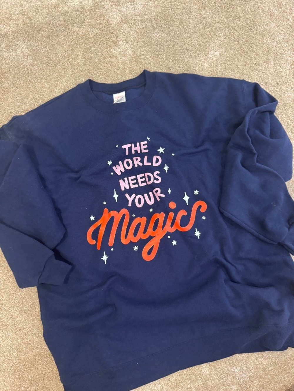 THE WORLD NEEDS YOUR MAGIC GRAPHIC SWEATSHIRT